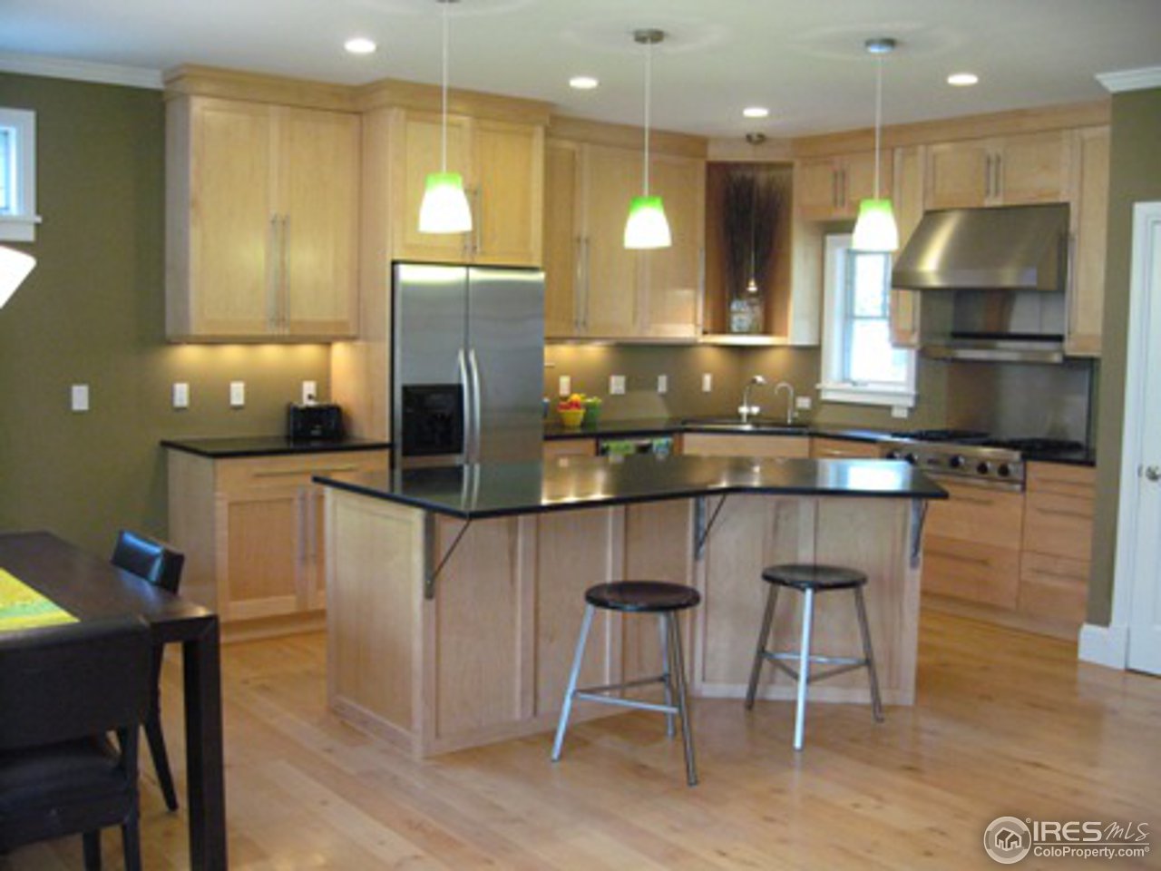 1023 Forest Avenue Boulder, CO 80304 - Photo 3 of 13 a kitchen with a table chairs refrigerator and microwave