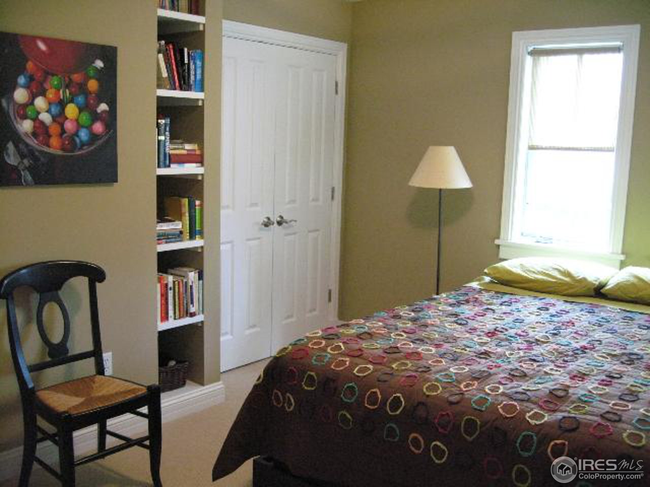 1023 Forest Avenue Boulder, CO 80304 - Photo 9 of 13 a bedroom with a bed and a bookshelf