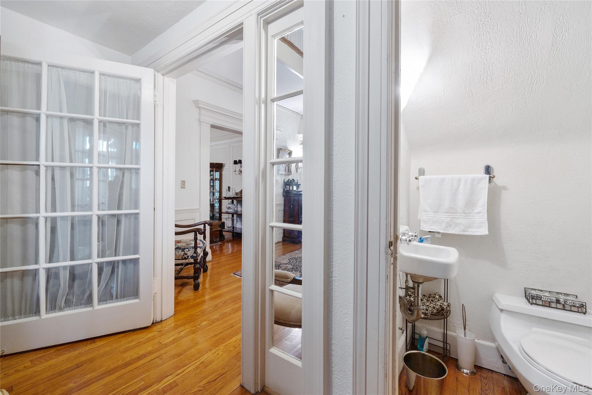 1-27 Beverly Road Queens, NY 11363 - Photo 39 of 46 a view of hallway with wooden floor and furniture
