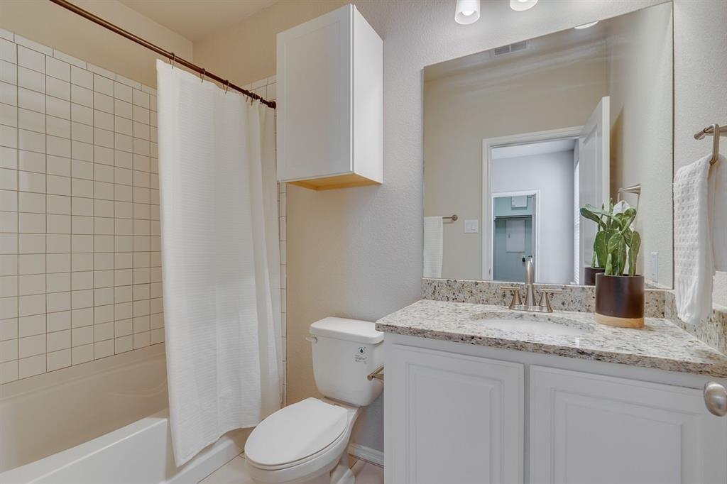 2707 McCart Avenue, Unit 209 Fort Worth, TX 76110 - Photo 18 of 25 a bathroom with a granite countertop sink toilet and shower