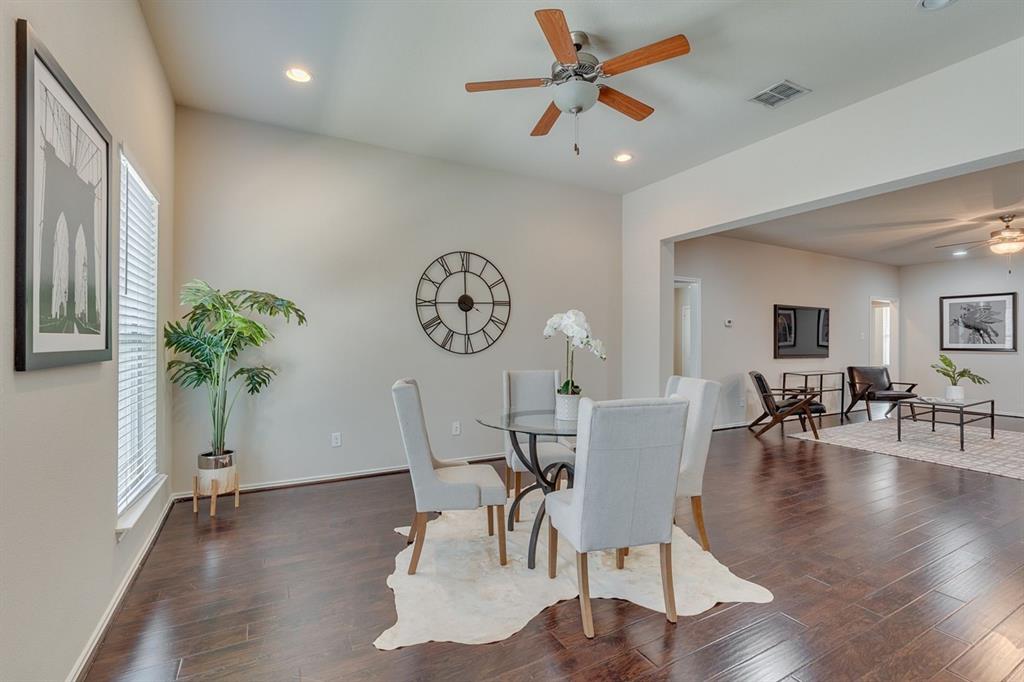 2707 McCart Avenue, Unit 209 Fort Worth, TX 76110 - Photo 3 of 25 a view of a dining room with furniture and wooden floor