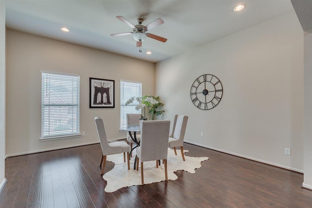2707 McCart Avenue, Unit 209 Fort Worth, TX 76110 - Photo 4 of 25 a view of a dining room with furniture window and wooden floor
