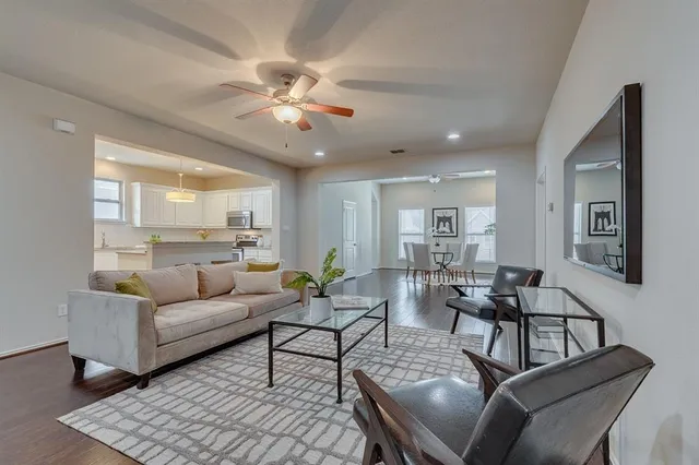a living room with furniture and a chandelier