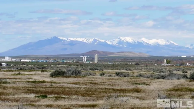 a view of a town with mountains in the background