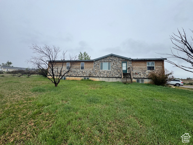 580 East 400 North Spring City, UT 84662 - Photo 2 of 40 View of front of home with entry steps, stone siding, and a front lawn