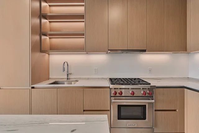 a kitchen with granite countertop a stove and a sink