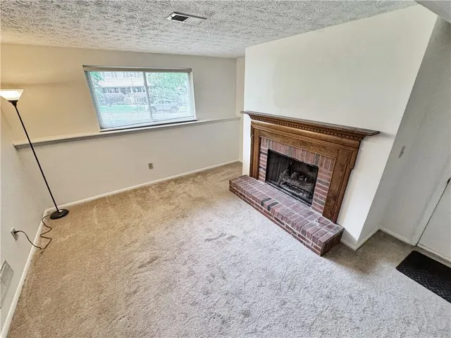 a view of an empty room with a fireplace