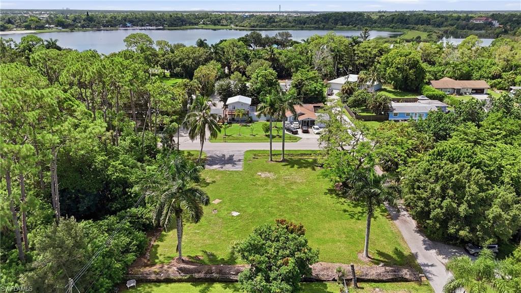 3417 Guilford Road Naples, FL 34112 - Photo 13 of 18 Expansive green space with mature trees, established roadways, and water frontage