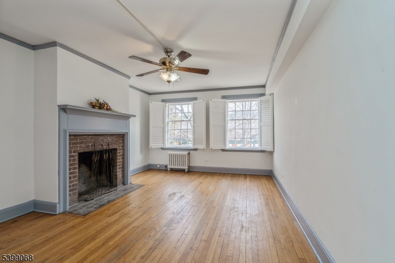 31 Palmer Square West, Unit B Princeton, NJ 08542 - Photo 2 of 13 a view of empty room with wooden floor and fireplace