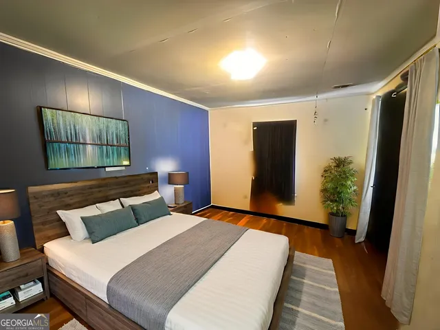 a bedroom with a bed and a mirror