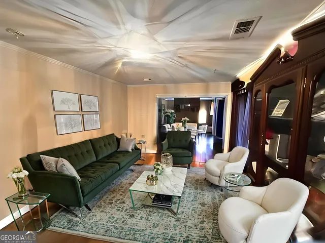 a living room with furniture ceiling fan and a rug