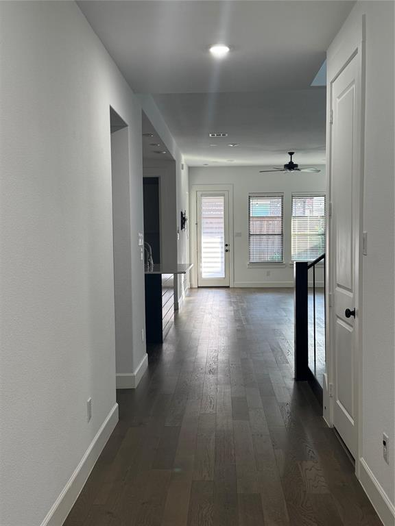 2152 Hermann Lane Carrollton, TX 75010 - Photo 14 of 18 a view of a hallway with wooden floor and windows