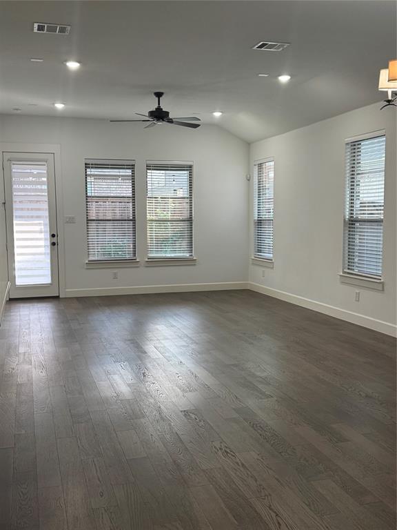 2152 Hermann Lane Carrollton, TX 75010 - Photo 15 of 18 an empty room with wooden floor and windows with curtains view