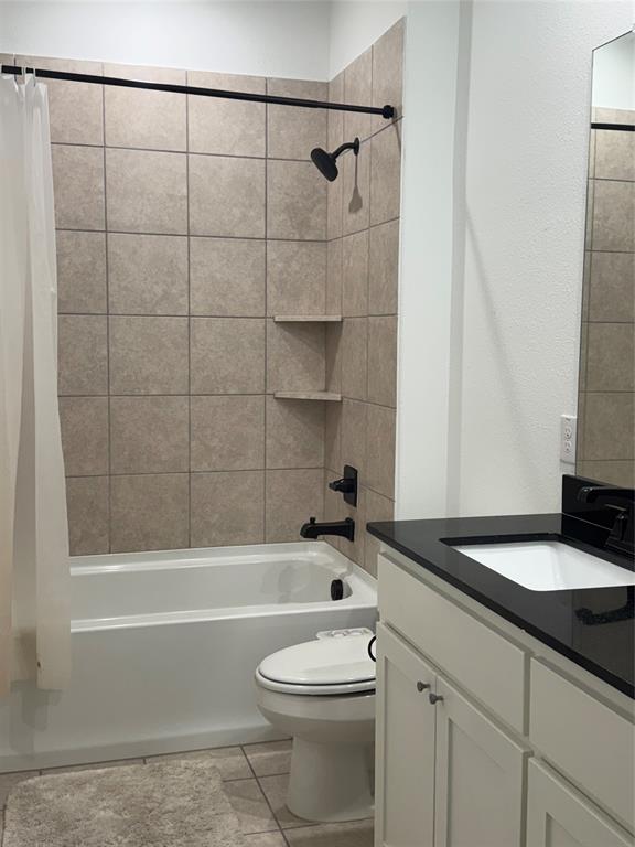 2152 Hermann Lane Carrollton, TX 75010 - Photo 5 of 18 a bathroom with a granite countertop bathtub shower sink vanity and toilet