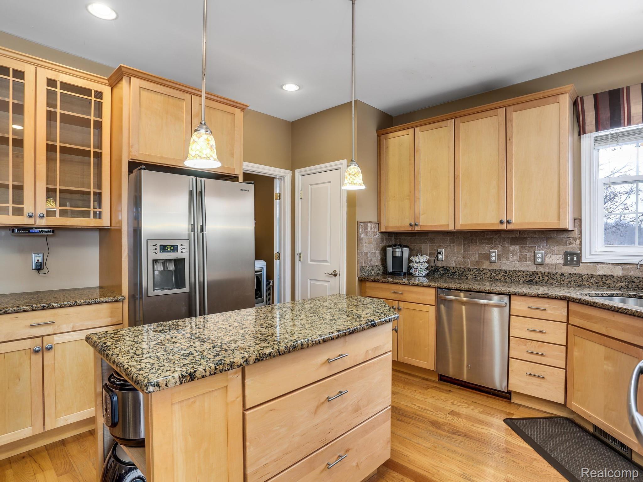 1067 Marsh Ridge Brighton, MI 48114 - Photo 11 of 39 The upgraded stainless appliances stay. Ceramic tile back splash surrounds the kitchen.