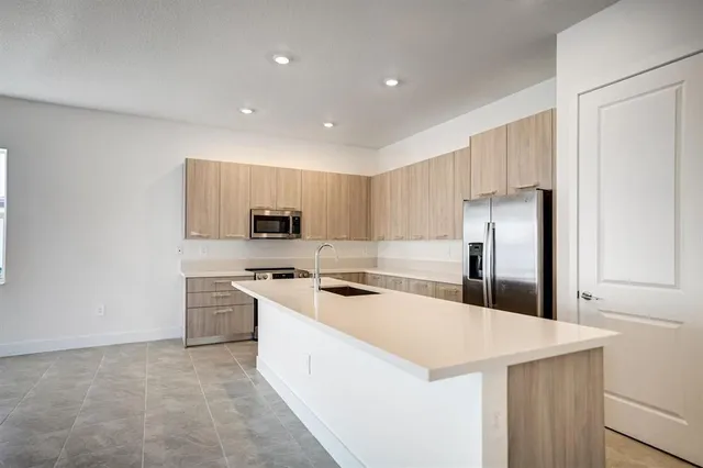 a bathroom with a sink a toilet a mirror and shower