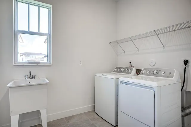 a bath tub sitting next to a white toilet and a sink