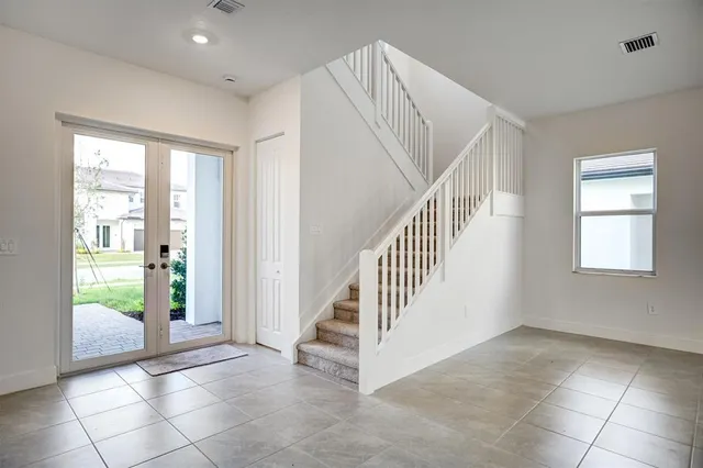 an empty room with windows and closet