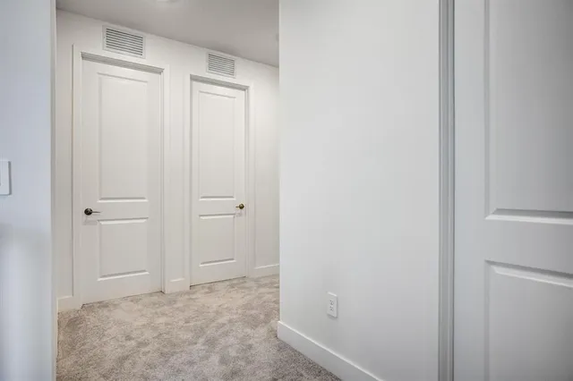 a view of an empty room and a window