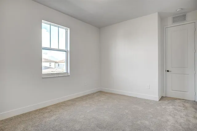 a view of a white house in front of a big yard