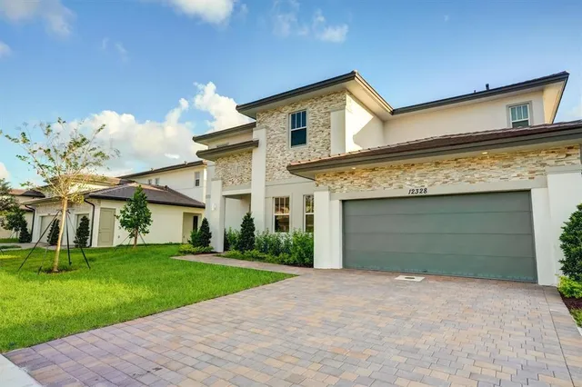 a front view of a house with a yard and garage