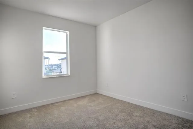 an aerial view of a house with a garden and lake view