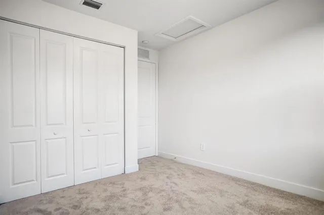 a front view of a house with a garden and plants