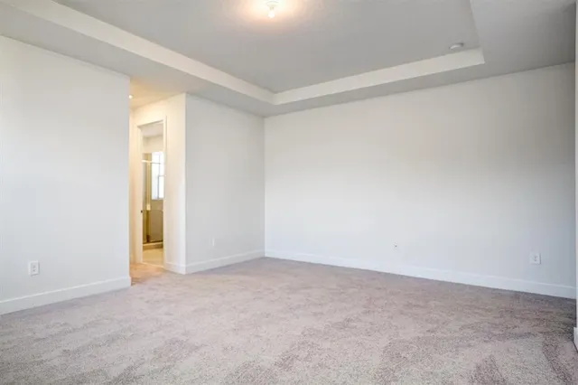a kitchen with kitchen island stainless steel appliances a dining table chairs sink and cabinets