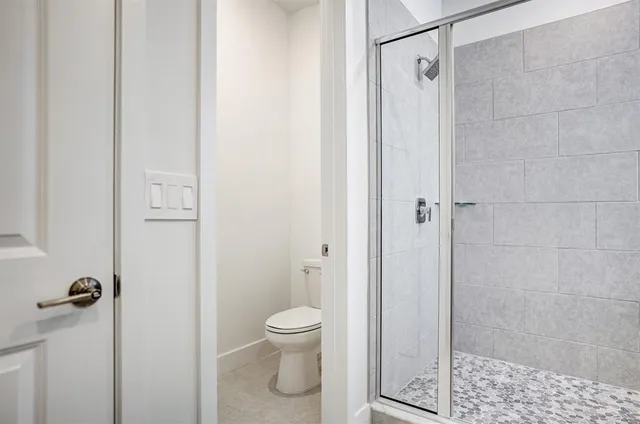 a bedroom with a bed and a potted plant