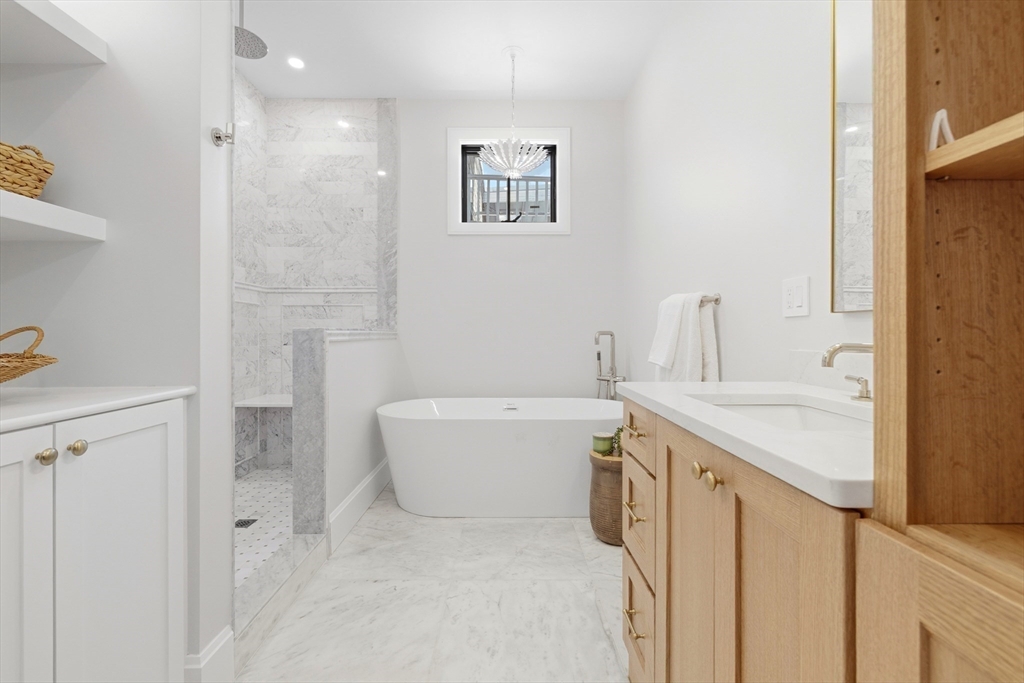 847 East 5th Street, Unit 2 Boston, MA 02127 - Photo 19 of 24 a bathroom with a granite countertop sink a toilet a shower and a mirror