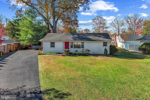 a front view of house with yard and trees around