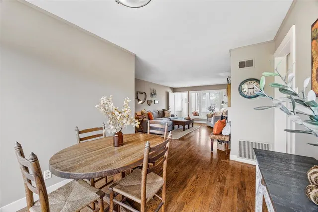 a dining room with furniture and wooden floor