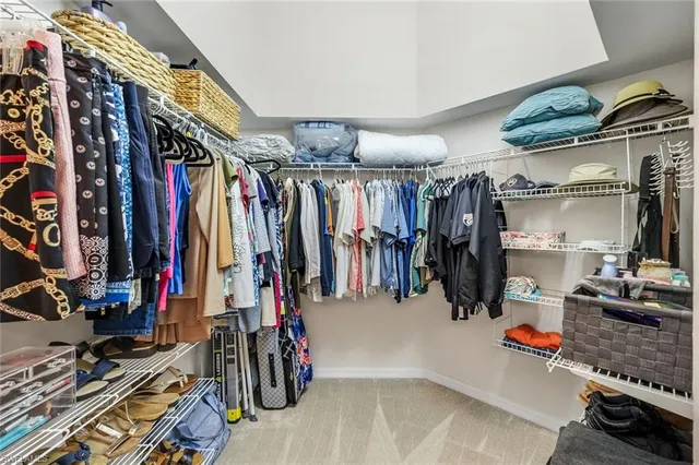 a bathroom with a sink a toilet a large mirror and shower