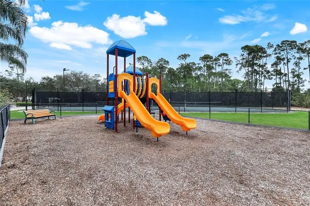 a view of a swimming pool with a bench in the patio