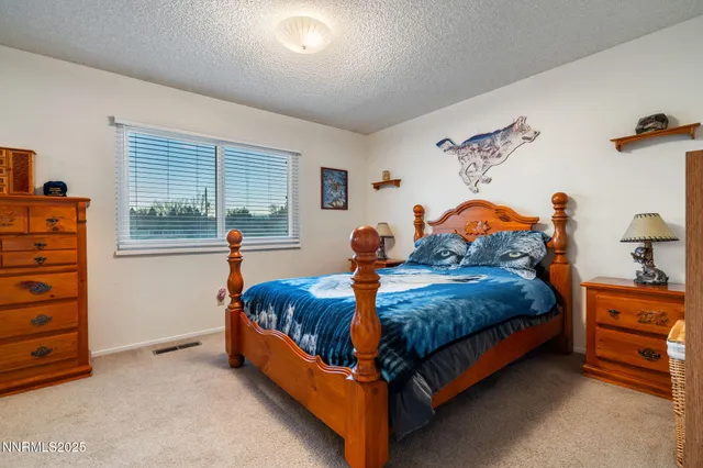 a bedroom with a bed and a large mirror