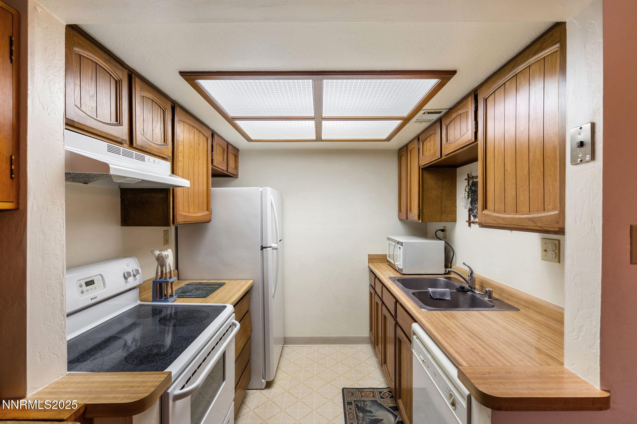 2282 Cannonball Road Sparks, NV 89431 - Photo 6 of 21 a kitchen with stainless steel appliances granite countertop a stove a sink and a refrigerator