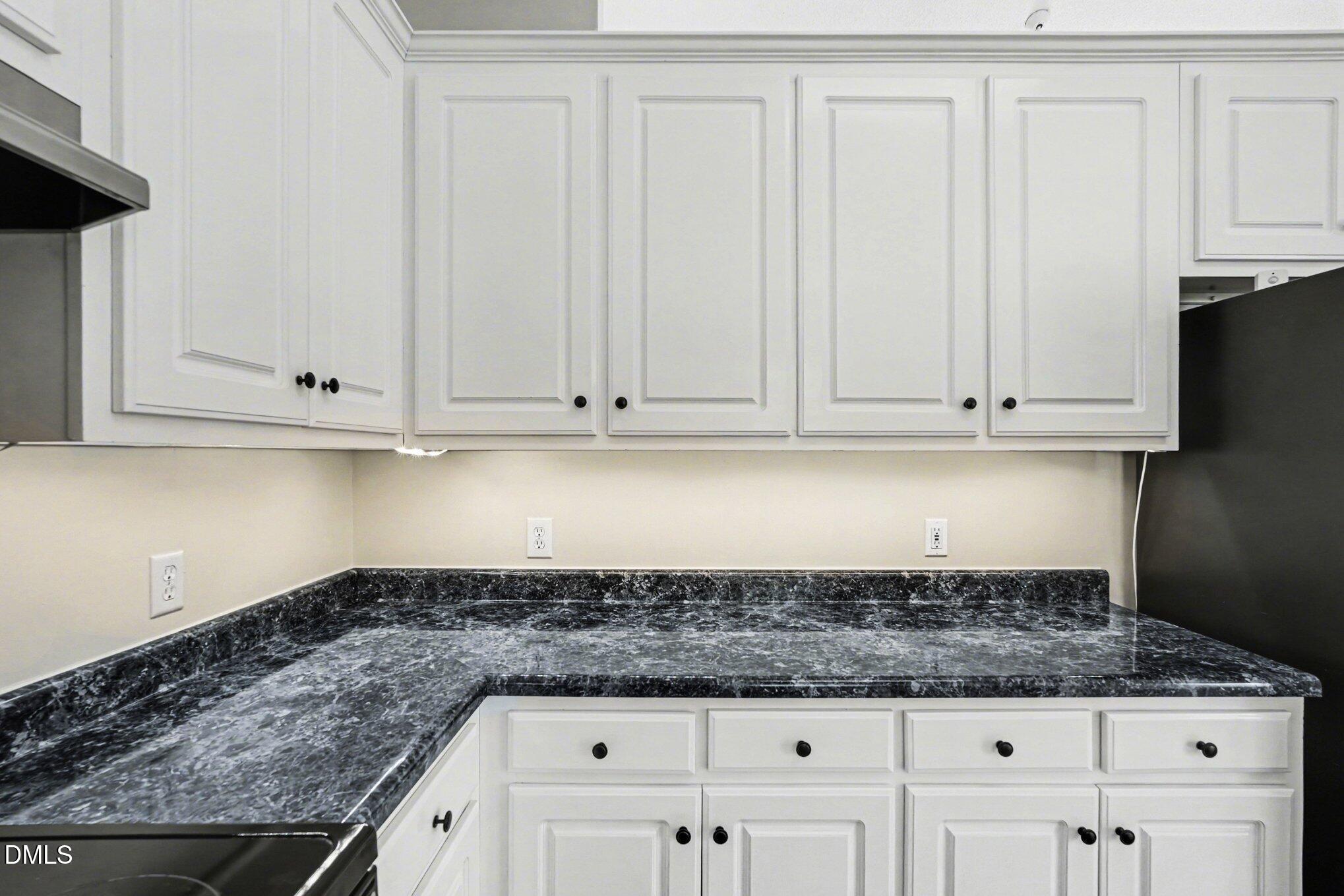 284 Dullis Circle Garner, NC 27529 - Photo 12 of 35 a kitchen with granite countertop white cabinets and a white stove
