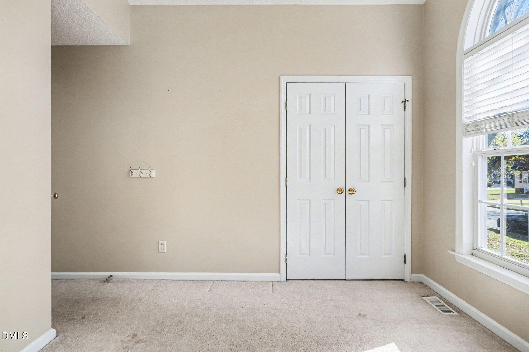 284 Dullis Circle Garner, NC 27529 - Photo 17 of 35 an empty room with windows