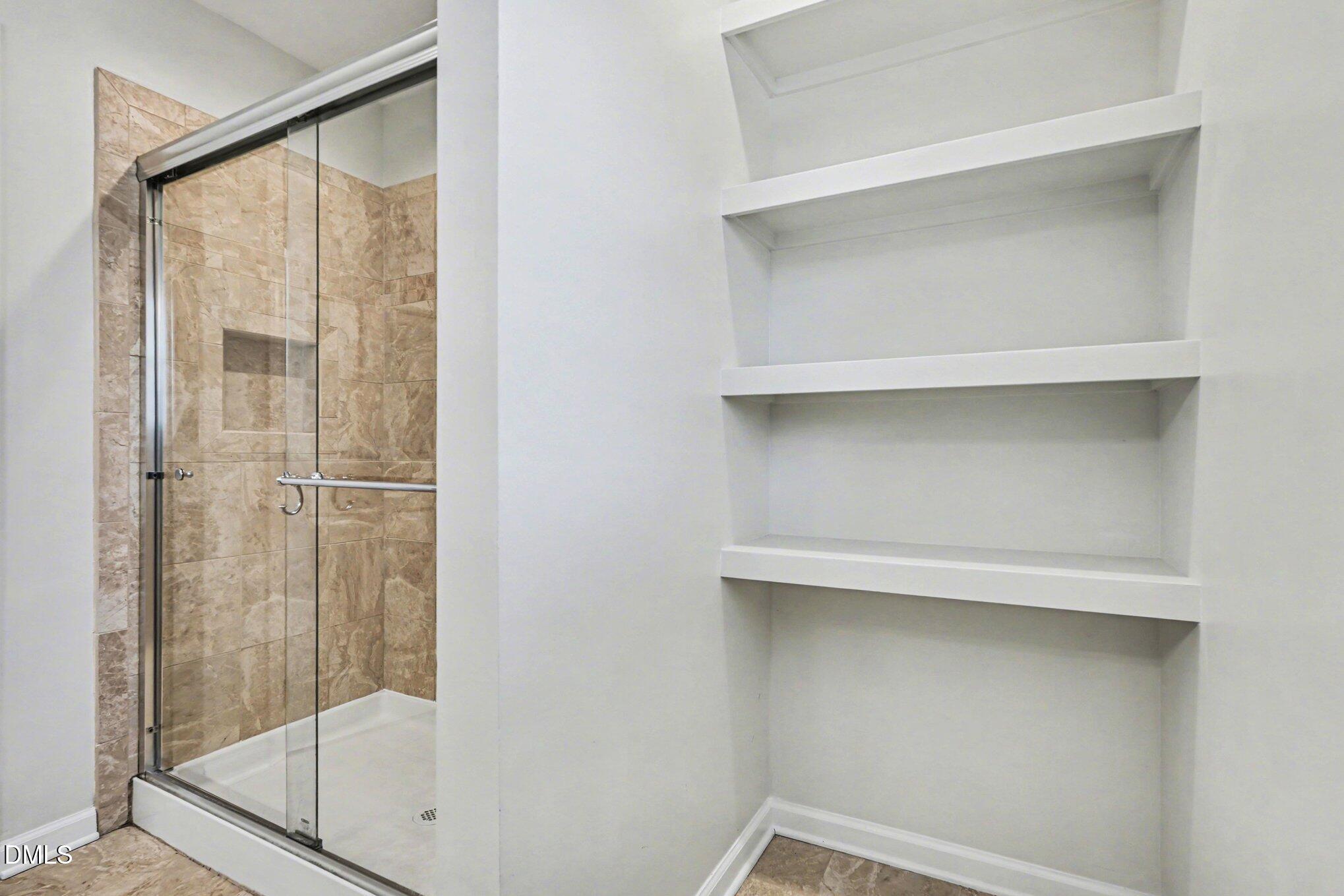 284 Dullis Circle Garner, NC 27529 - Photo 25 of 35 a bathroom with a glass shower door