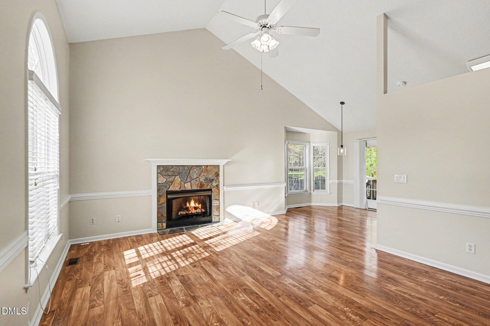 284 Dullis Circle Garner, NC 27529 - Photo 7 of 35 a view of an empty room with wooden floor fireplace and a window