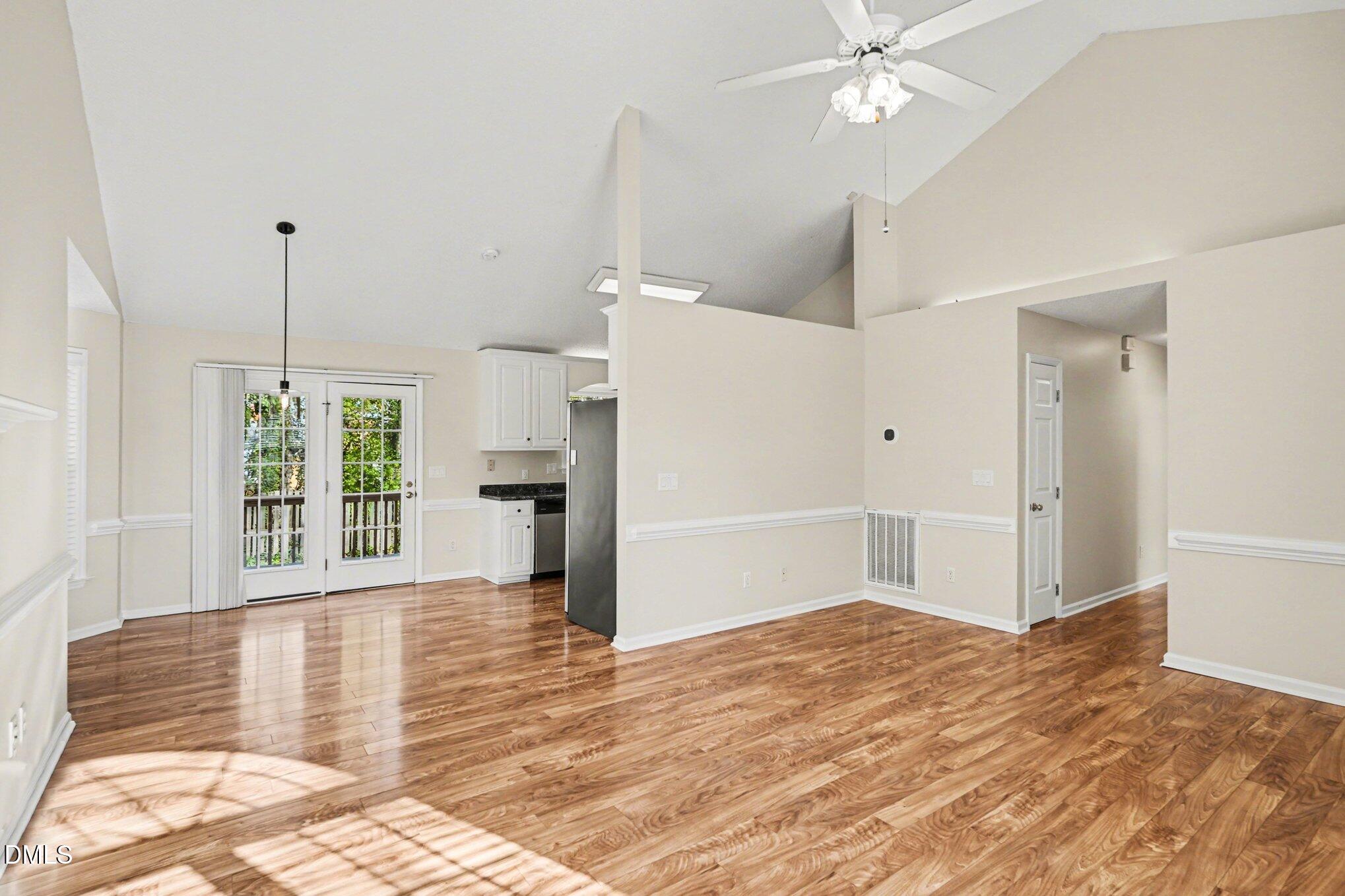 284 Dullis Circle Garner, NC 27529 - Photo 8 of 35 a view of a livingroom with wooden floor and a ceiling fan
