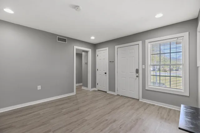 wooden floor in an empty room with a window