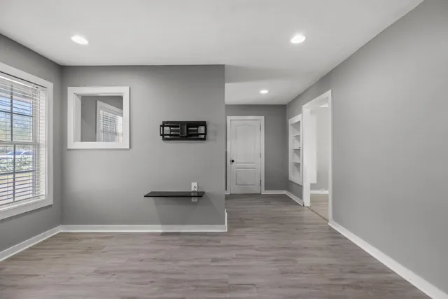 wooden floor in an empty room with a window