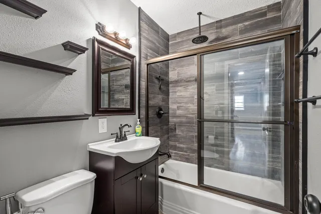 a bathroom with a sink toilet and shower