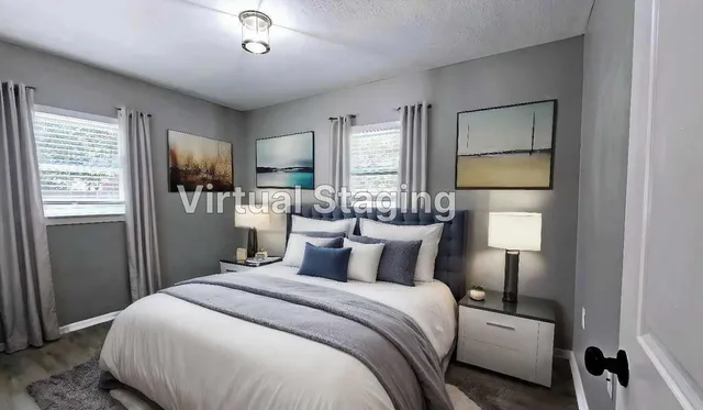 a bedroom with a bed and a large mirror