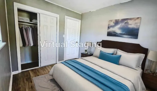 a bedroom with a bed and a painting on the wall