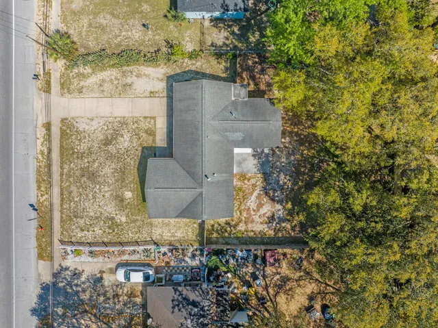 front view of a brick house with a yard