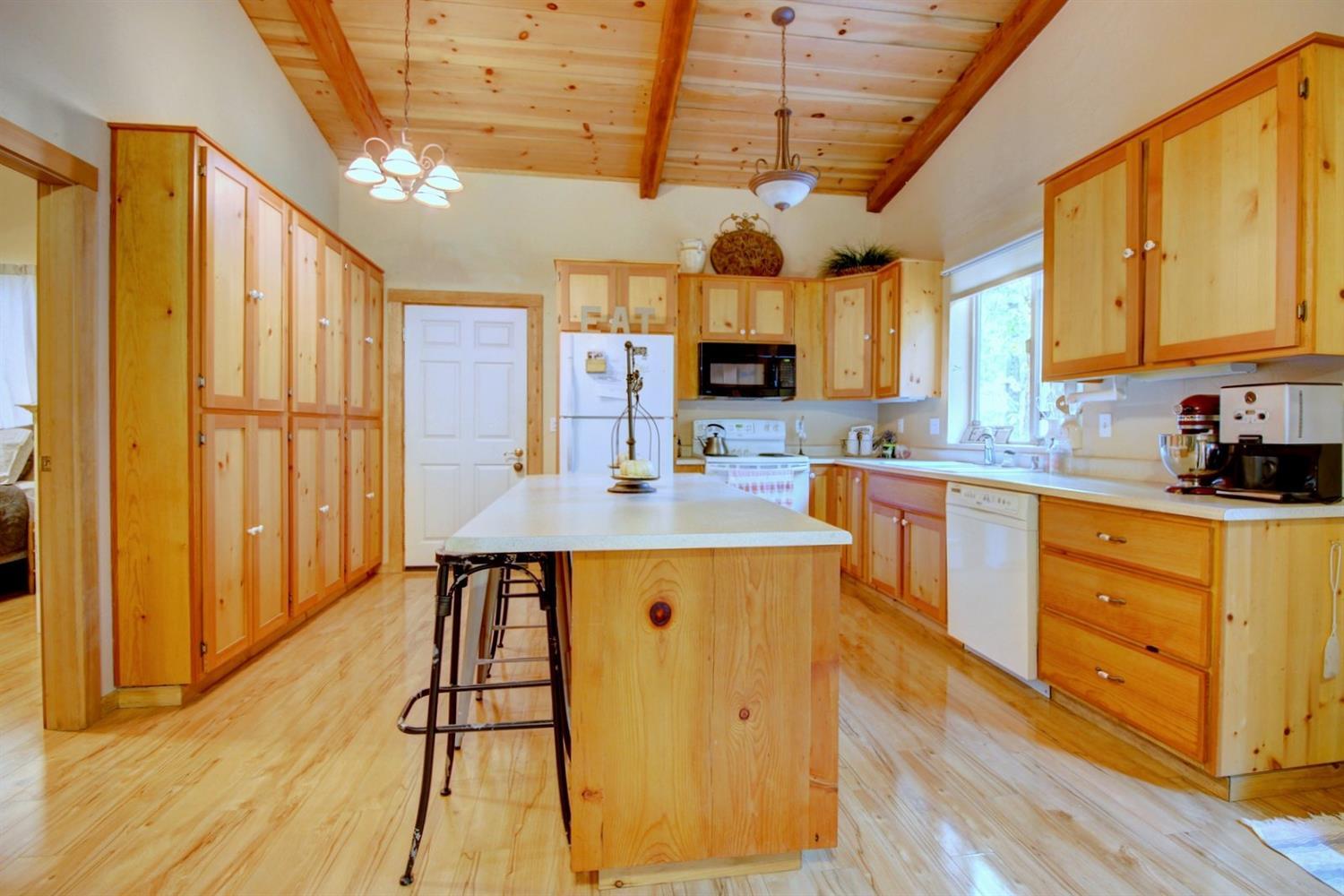 1065 Riessen Road Grants Pass, OR 97526 - Photo 22 of 32 a kitchen with stainless steel appliances granite countertop a sink a stove cabinets counter space and a window