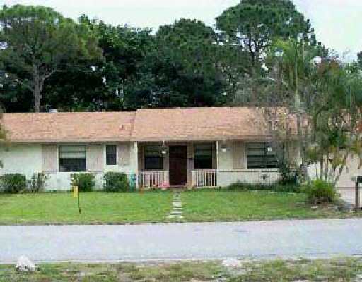 15308 Harrison Road Delray Beach, FL 33484 - Photo 1 of 1 a front view of a house with a garden and plants