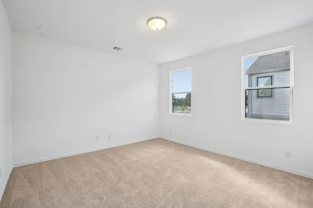 an empty room with windows and closet